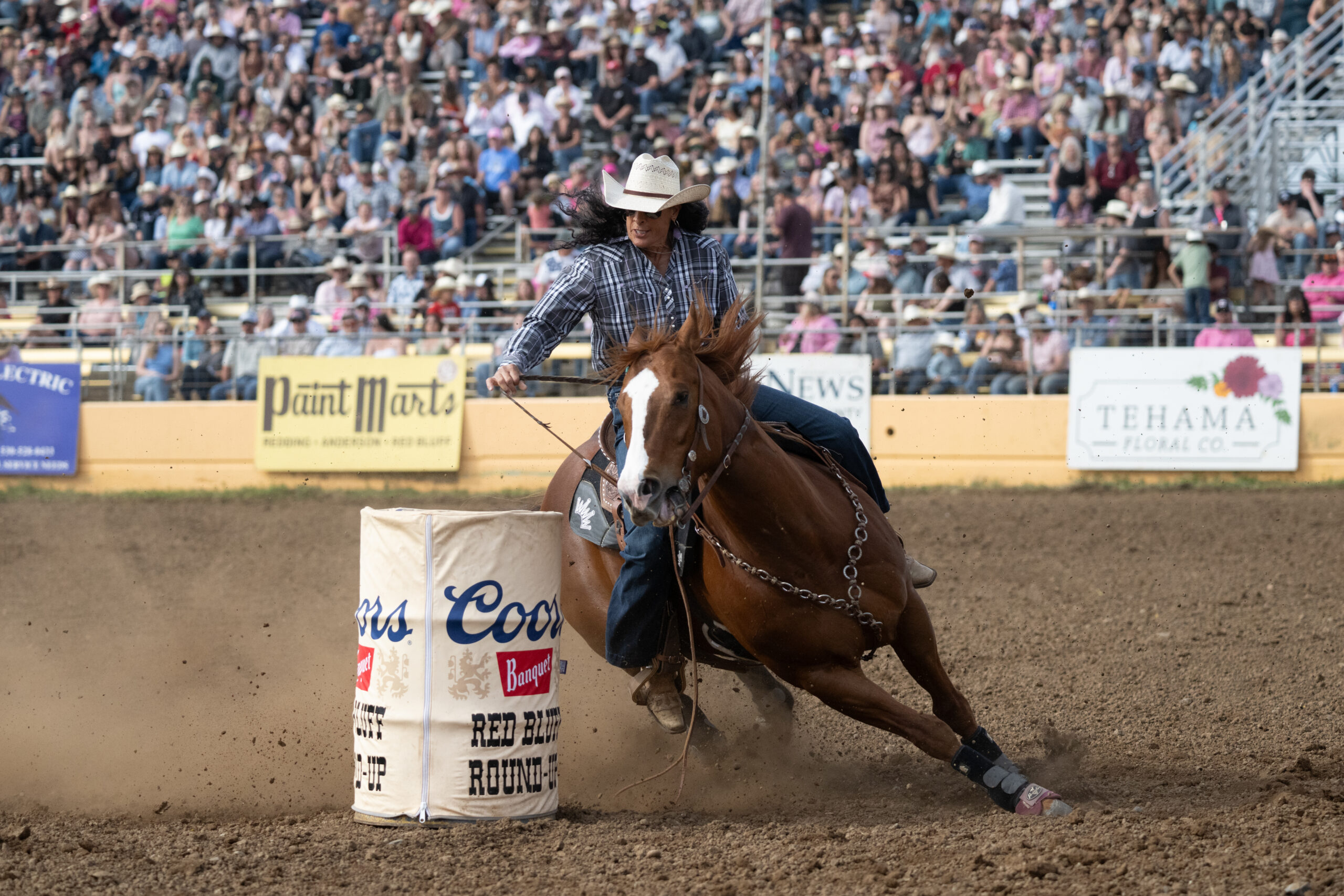 Kathy Petska slides around a barrel in Red Bluff on her horse