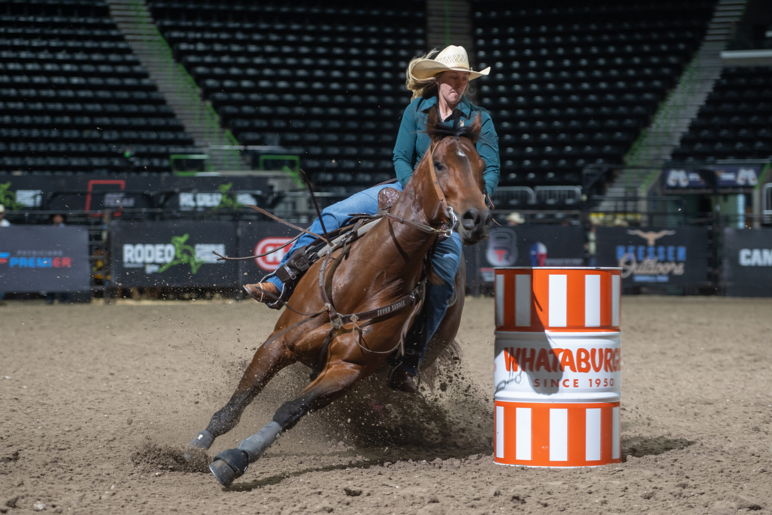 Katie Halbert turns a Whateburger barrel at Rodeo Corpus Christi on her horse