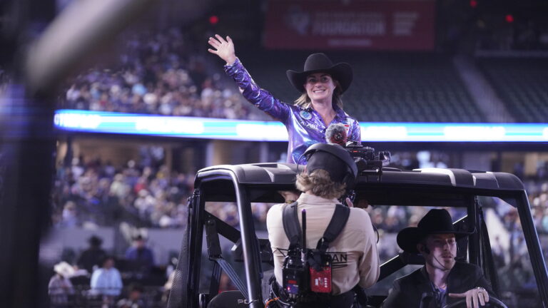 Hayle Stillwell waves as she takes her victory lap at The American