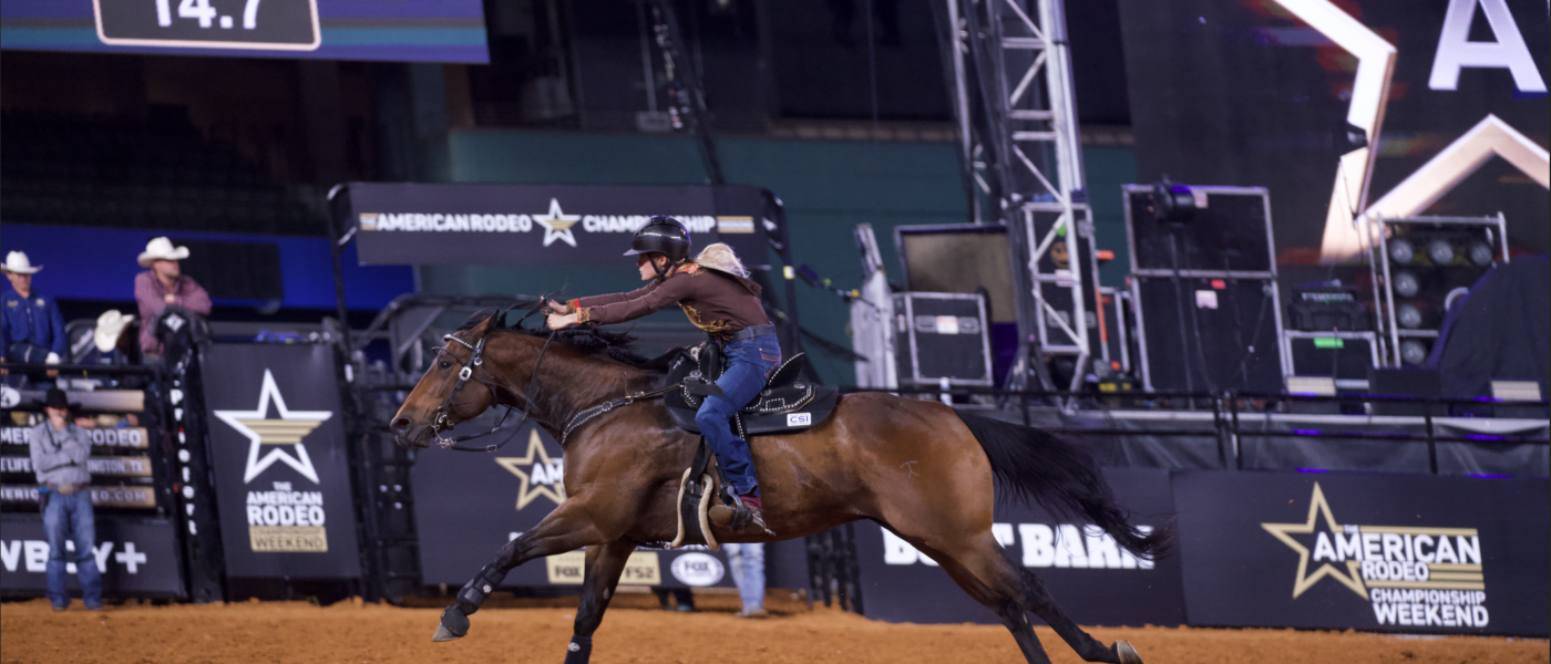 Hailey Krahenbuhl rides her horse at The American Rodeo running home