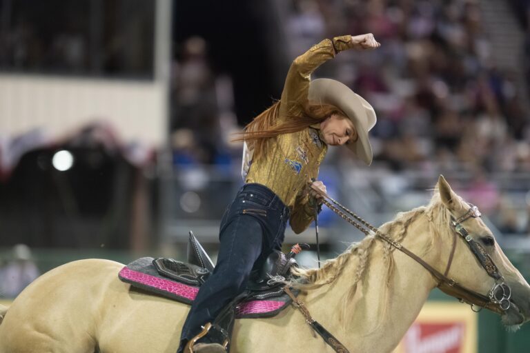 Emily Beisel fist pumps on her horse
