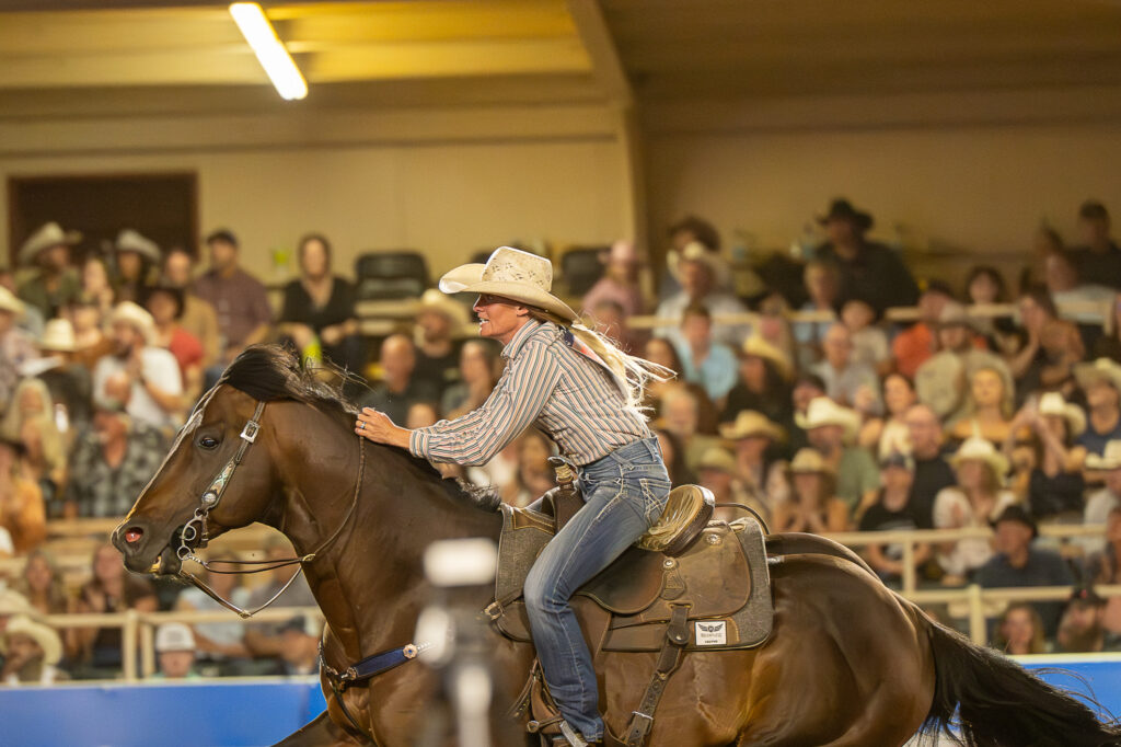 Caitlyn White encourages her horse forward during a run in Colorado Springs