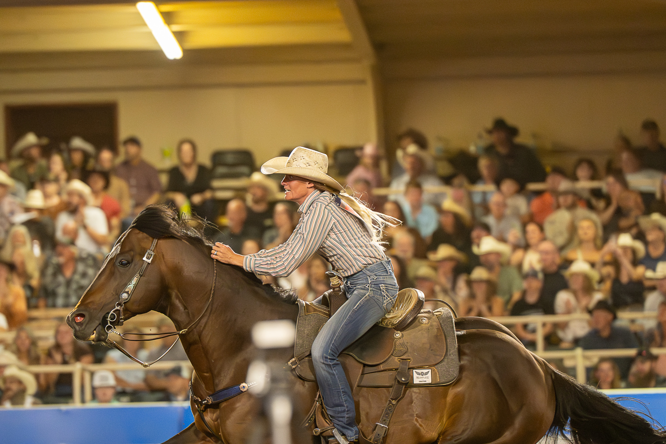 Caitlyn White encourages her horse forward during a run in Colorado Springs