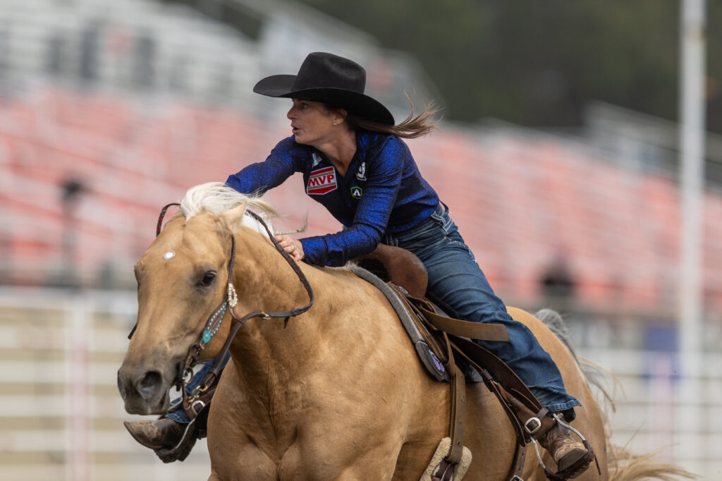 Hayle Stillwell runs her horse across the finish line at Salinas