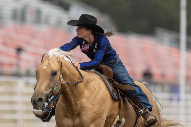 Hayle Stillwell runs her horse across the finish line at Salinas
