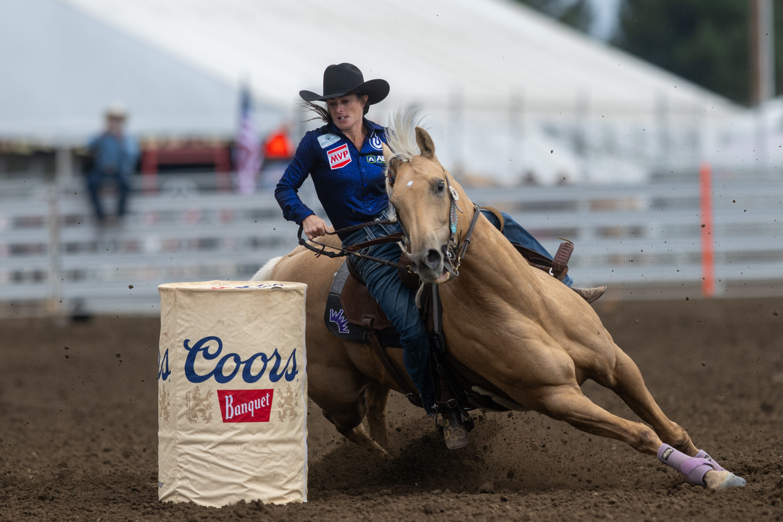 Hayle Stillwell turns a barrel on the yellow mare