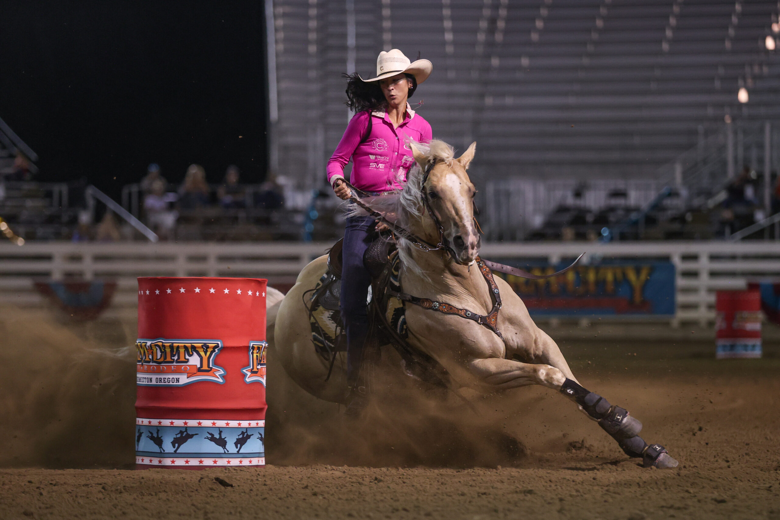 Mckenna Coronado turns a barrel on her yellow horse, Shine