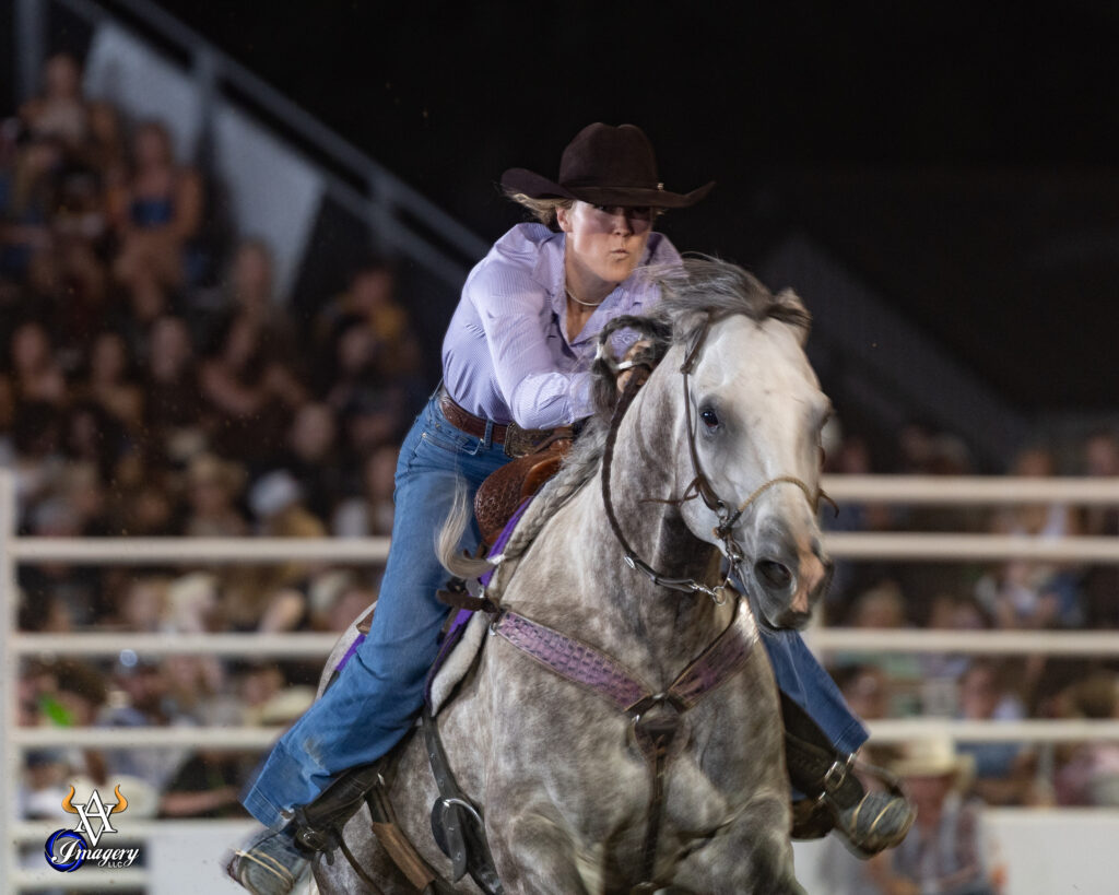 Raelin Jurgens pushes her horse across the finish line