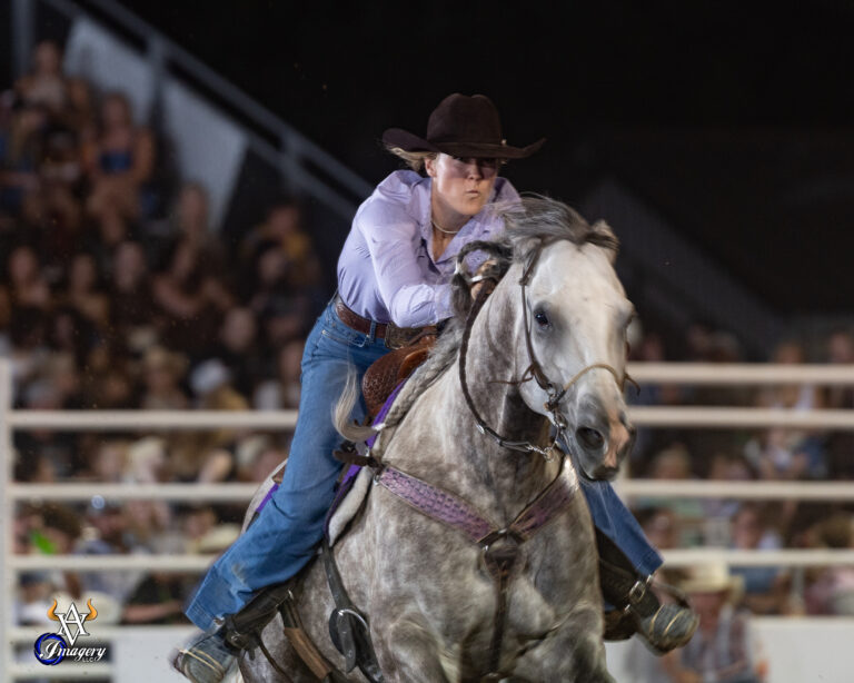 Raelin Jurgens pushes her horse across the finish line
