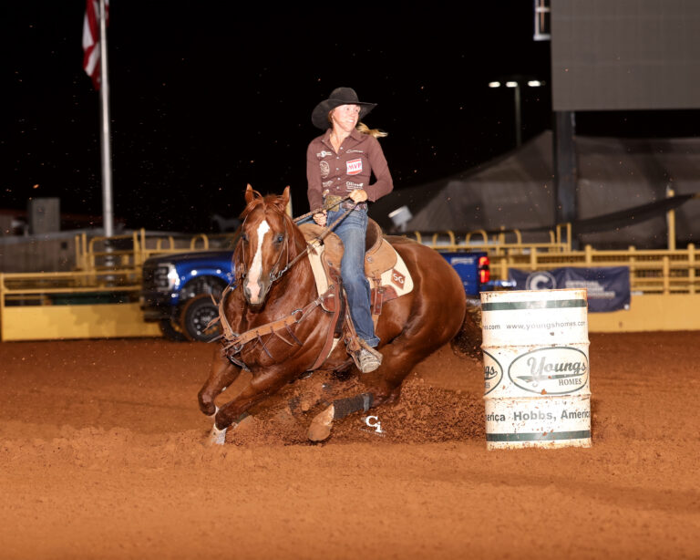 Sydney Graham turns a barrel on her stallion "Trump"