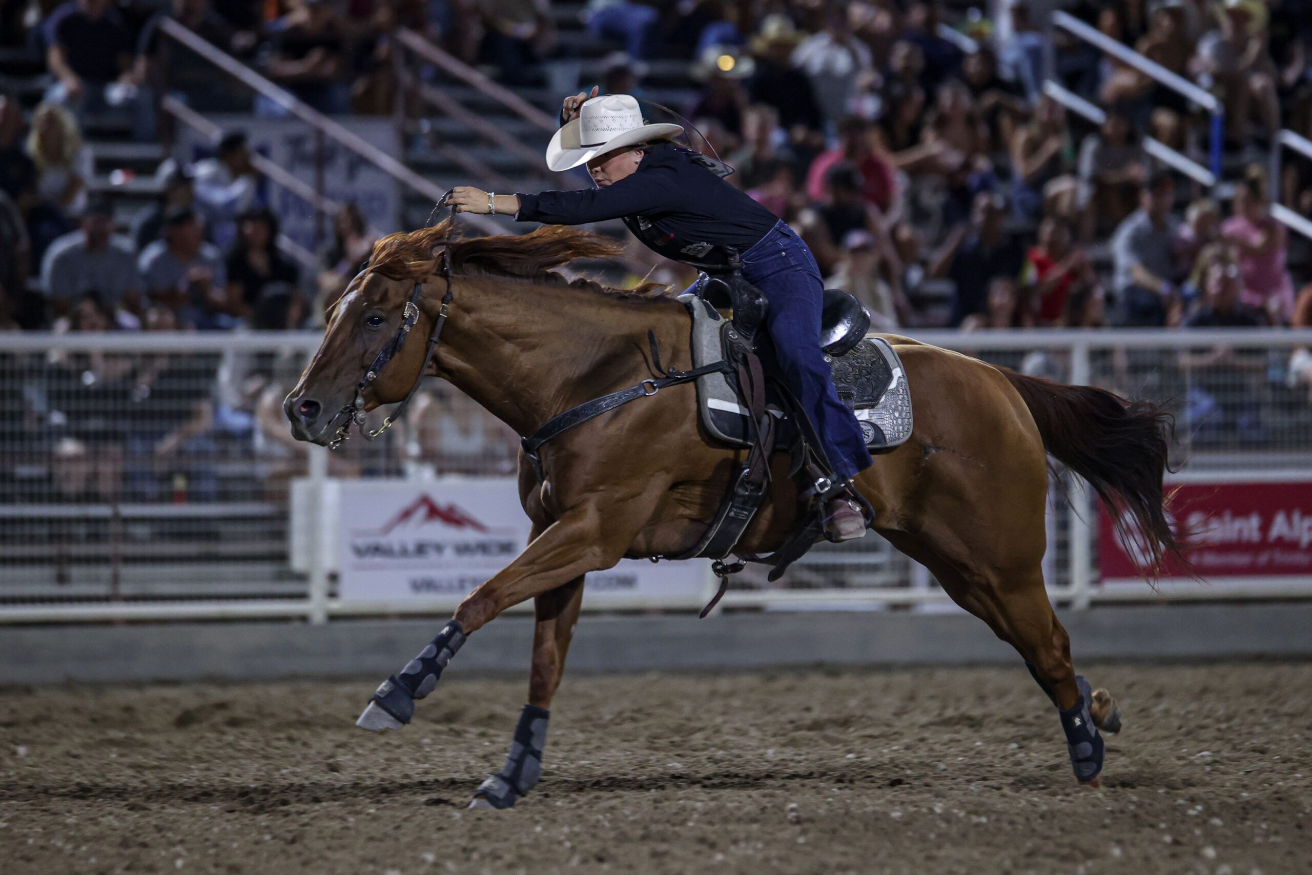 Makenzie Mayes crosses the finish line on her red horse
