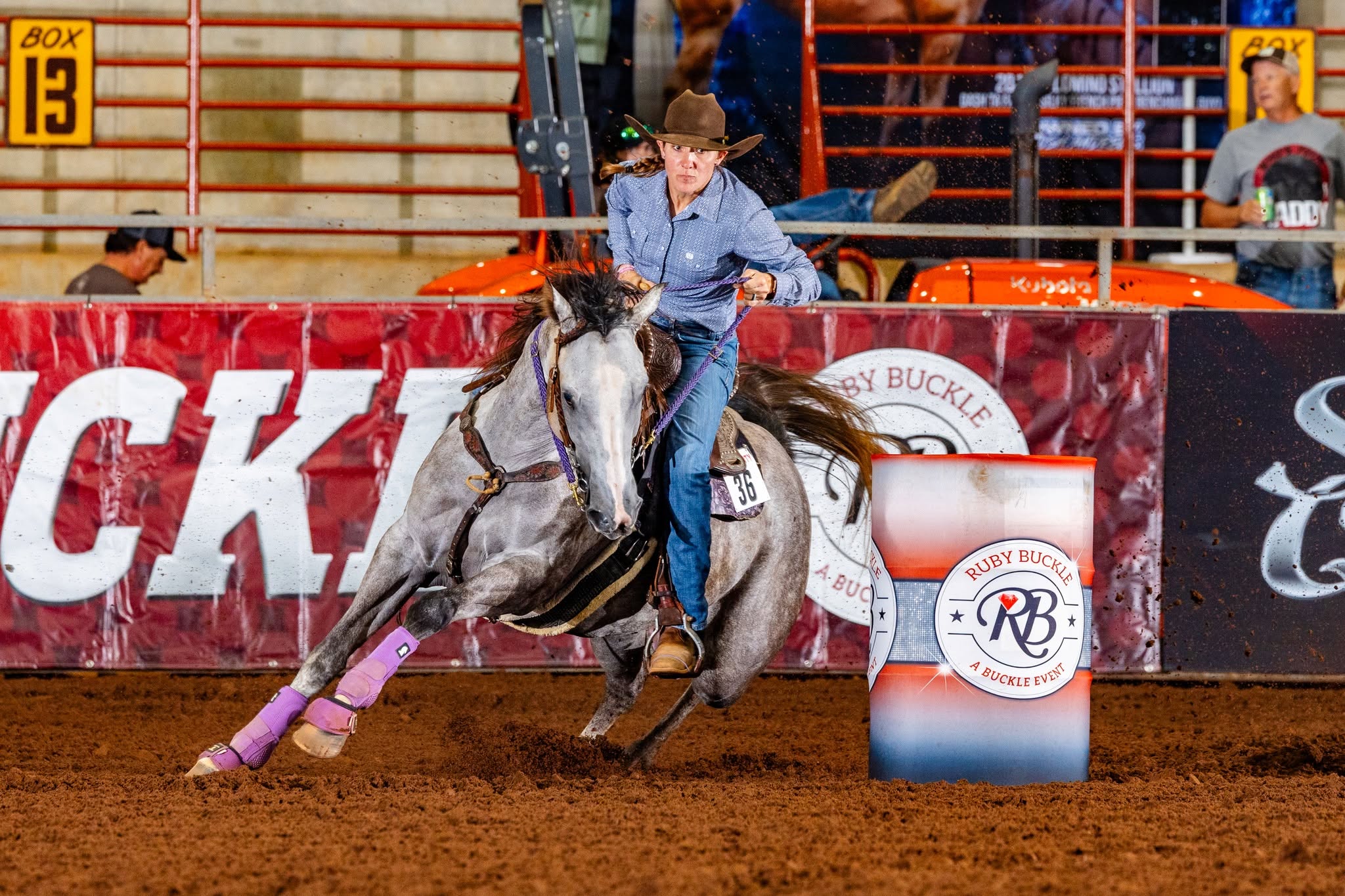Girl on white horse turning a Ruby Buckle barrel