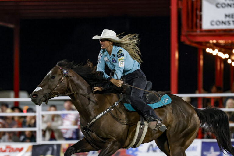 Michelle Alley hustles her horse across the timer
