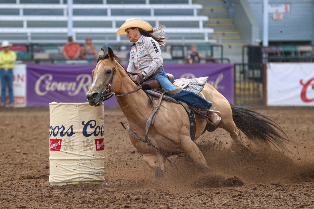 Lisa Lockhart banks a turn on the big buckskin mare, Rosa