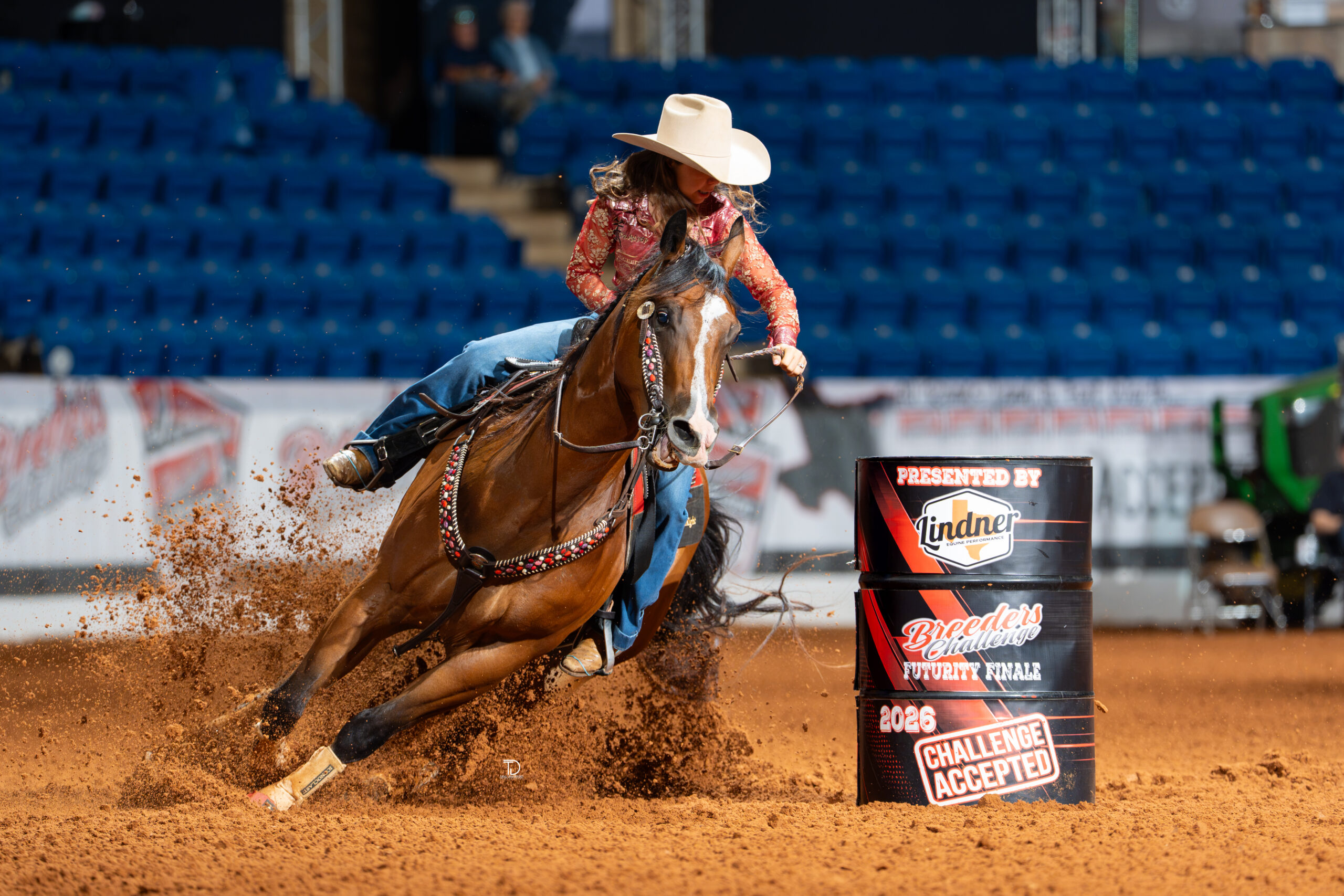 Dusky Lynn Hall turns a barrel on her little bay horse