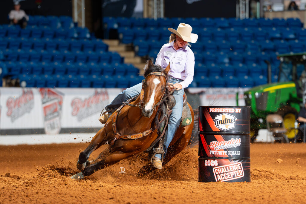 Joy Wargo turns a barrel on a bay horse