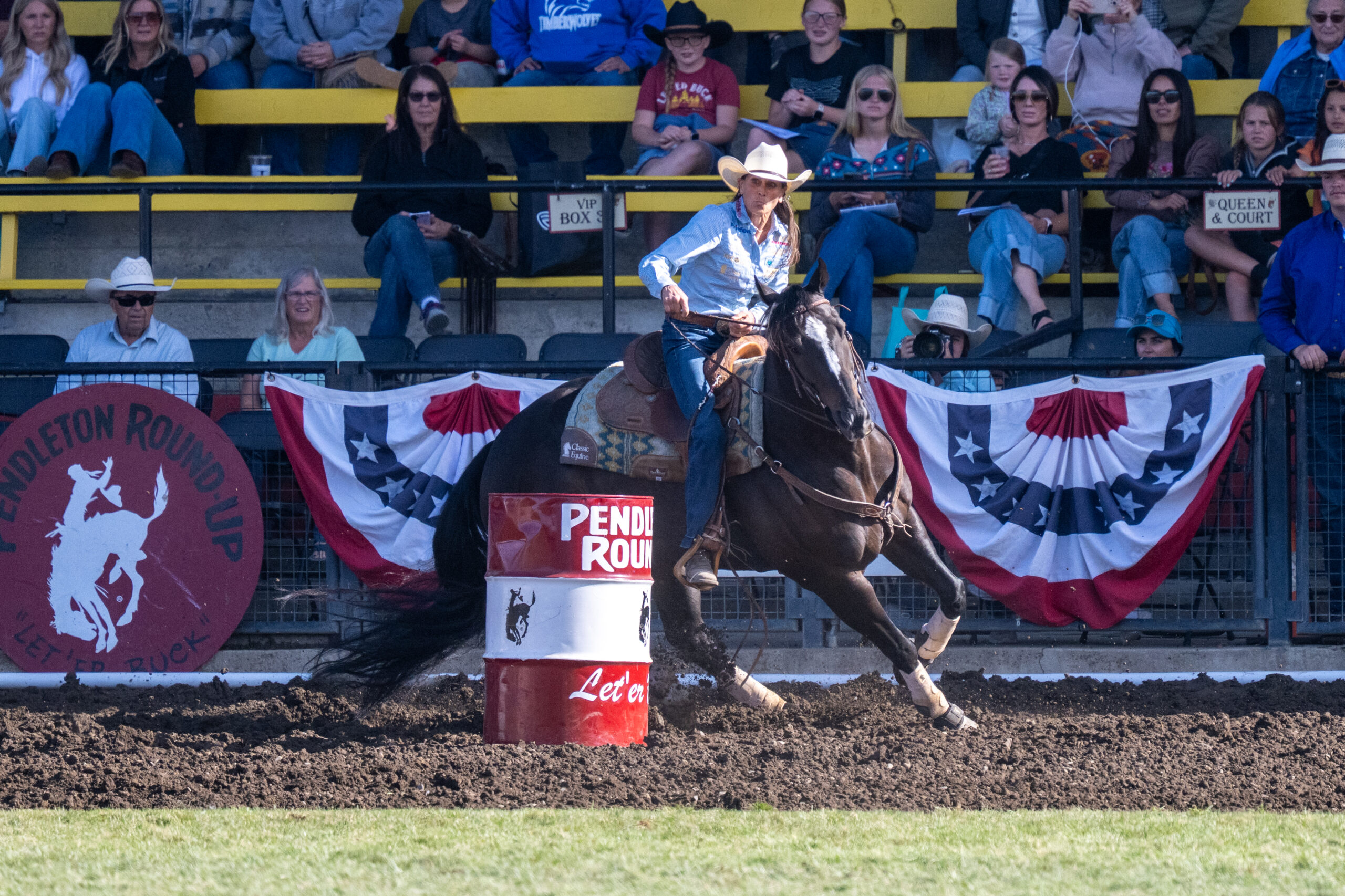 Lisa Lockhart turns a barrel at Pendleton Roundup on her black horse