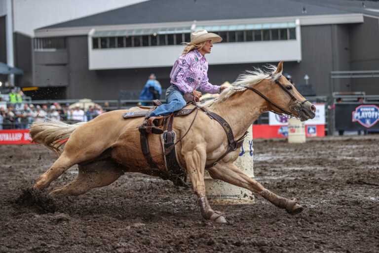 Carlee Otero turns a barrel on her beautiful yellow mare Regina