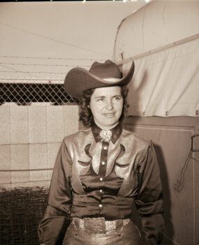 A woman poses in a cowboy hat