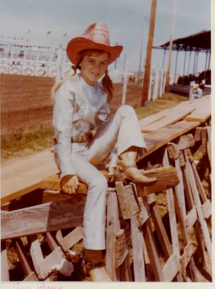 a girl in a cowboy hat and pigtails