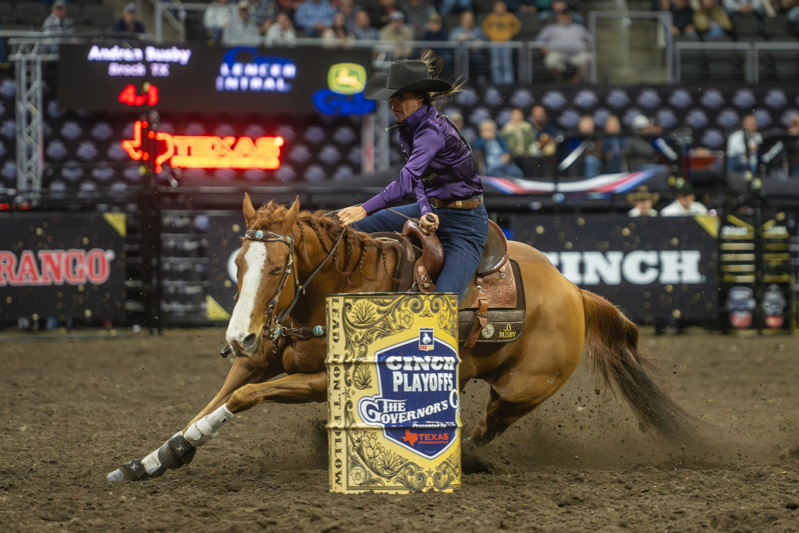 Andrea Busby turns a barrel on her sorrel gelding
