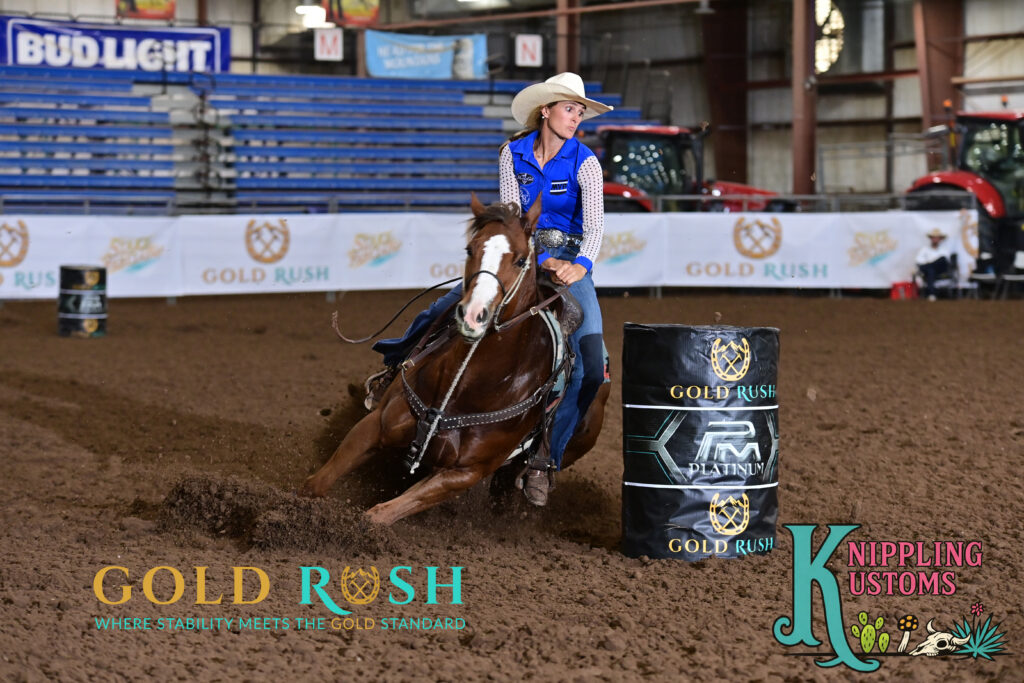 Taylor Miniat turns a barrel on a red horse