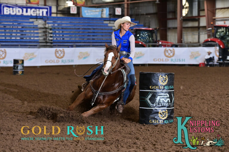 Taylor Miniat turns a barrel on a red horse