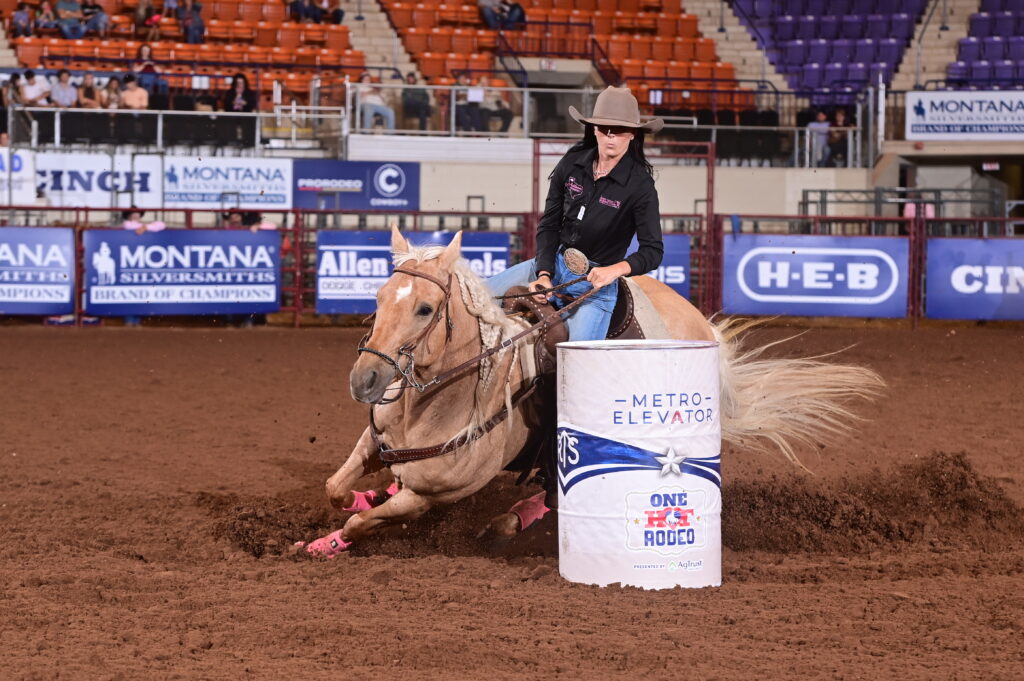 Morgan Addison turns a white barrel on a yellow horse