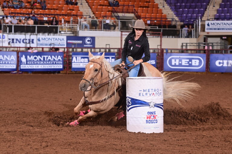 Morgan Addison turns a white barrel on a yellow horse