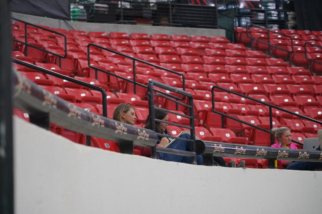 Woman in red bleachers 