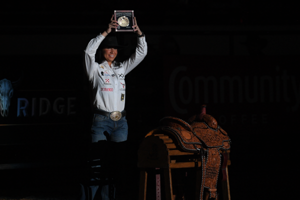 Martha Angelone accepts breakaway roping world championship saddle and buckle.