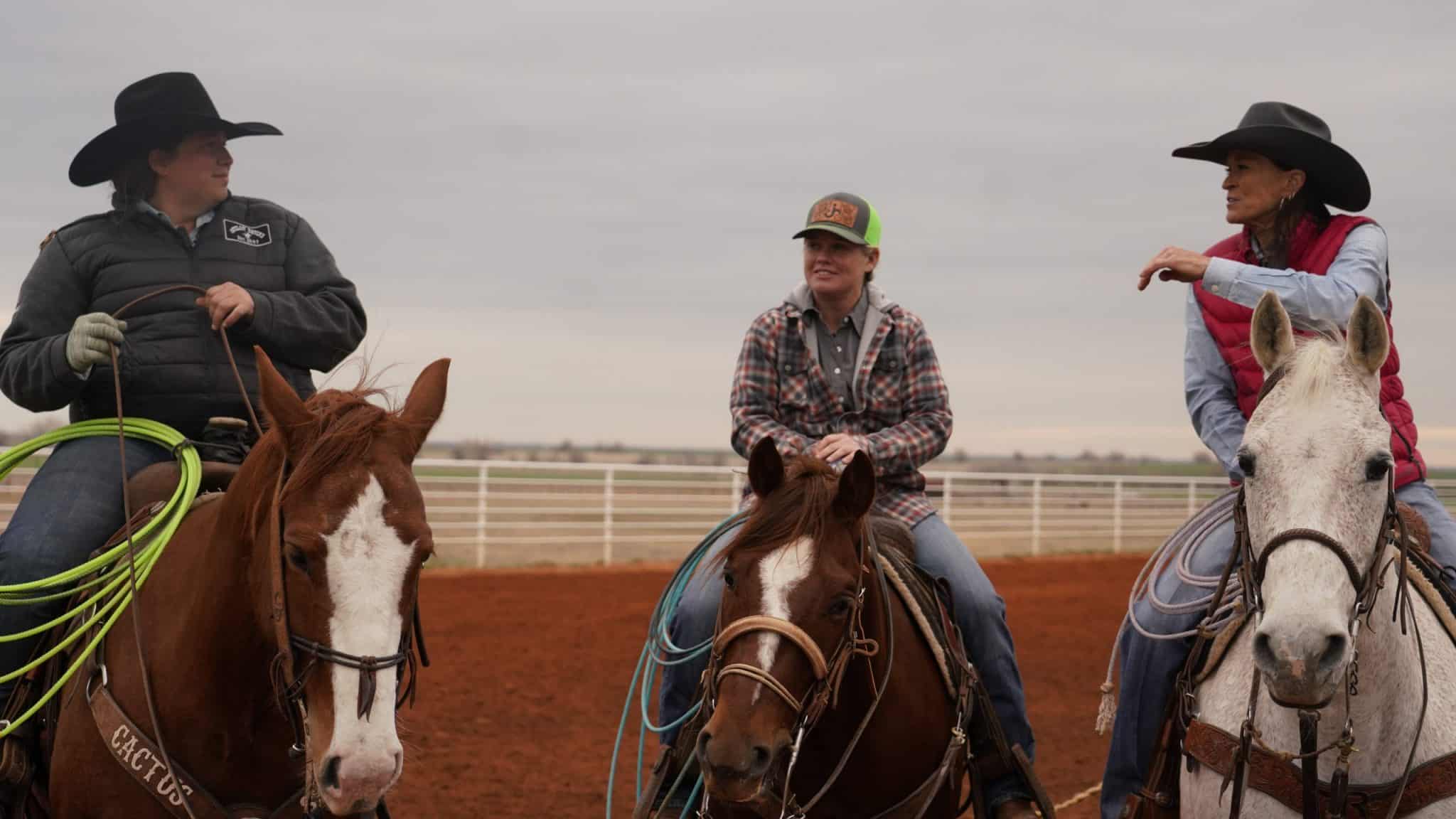 Female ropers talking during practice