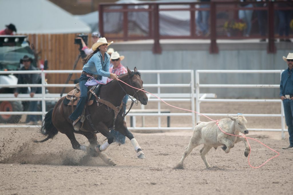 Joey Williams catches her calf at cheyenne frontier days