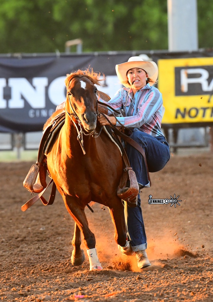 Haiden Thompson dismounts to tie her goat at the 2022 IFYR