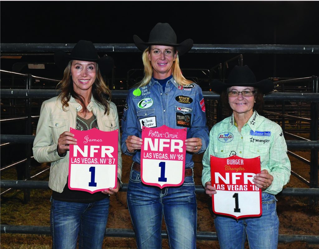 Charmayne James, Sherry Cervi and Mary Burger stand shoulder to shoulder holding NFR back numbers. 