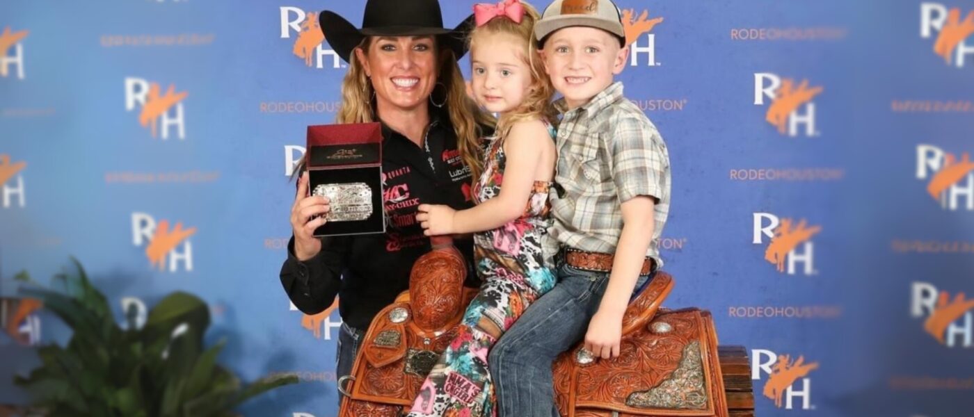 Jackie Crawford smiles after winning RodeoHouston 2024 with Journey and Creed in the saddle.