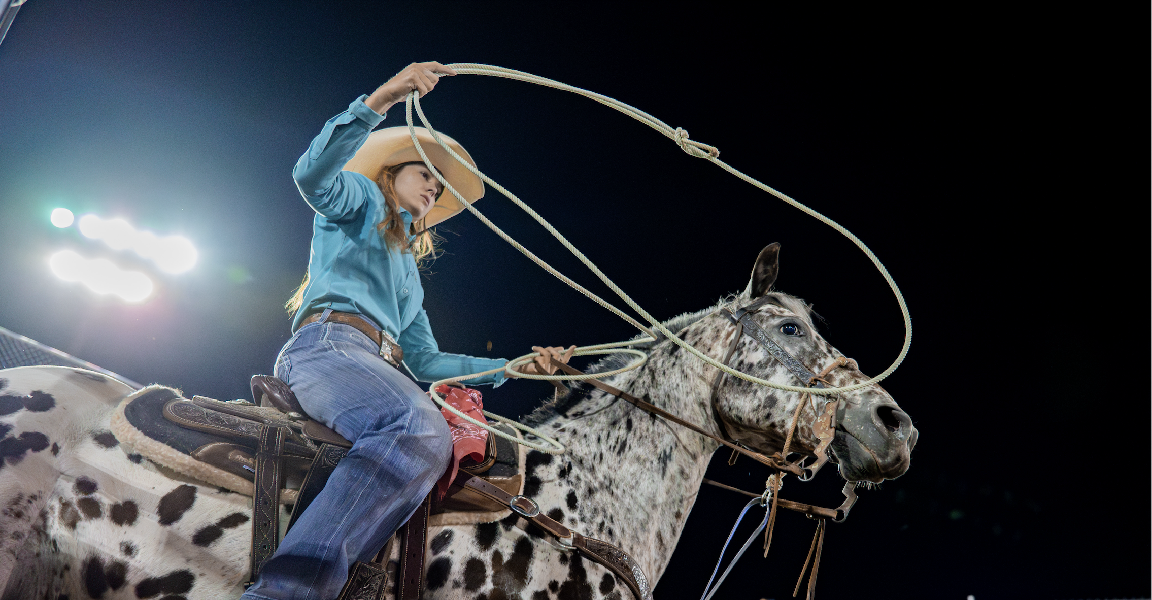 McKenna Hickton studies her rope before backing into the box on her trusty gelding "Spot" at the Farm-City Pro Rodeo in Hermiston, OR.