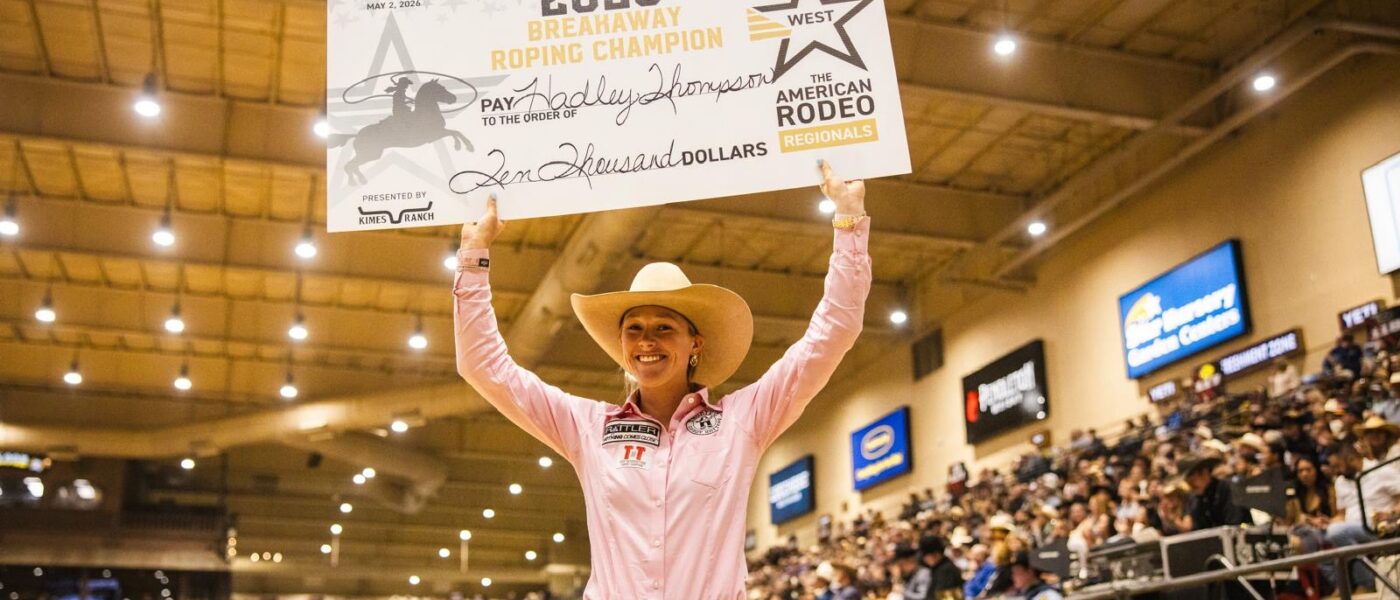 Hadley Thompson holds up her large check