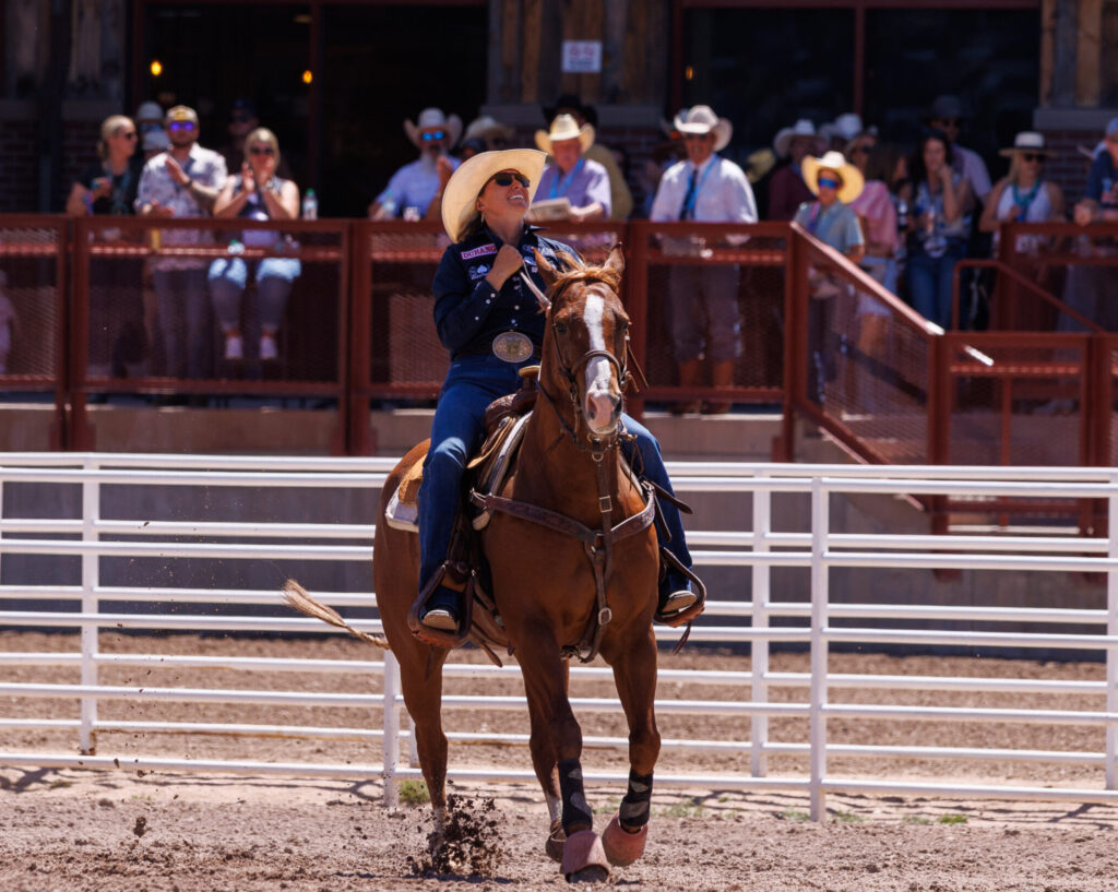 Cheyanne McCartney and horse Teddy riding out of the arena after goign 4.3 to win cheyenne frontier days