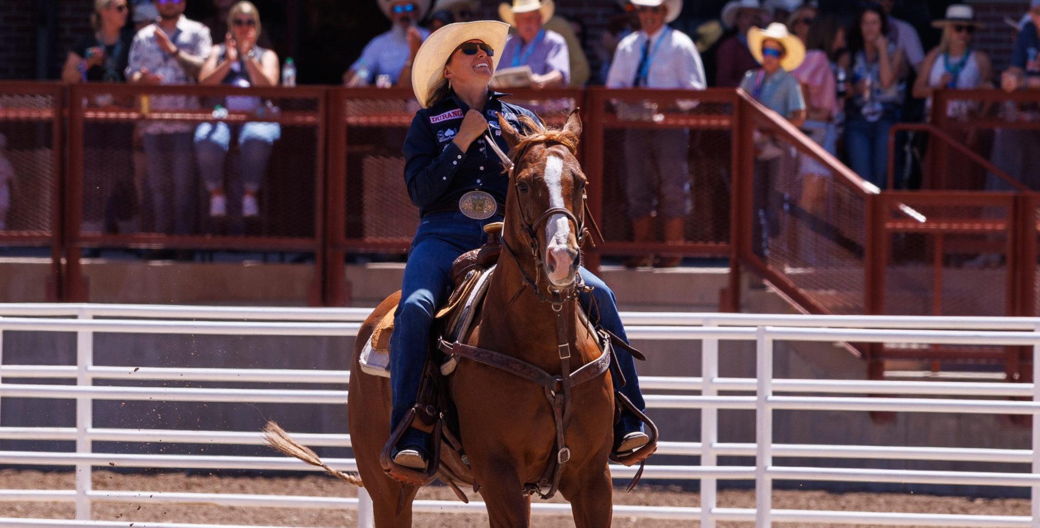 Cheyanne McCartney and horse Teddy riding out of the arena after goign 4.3 to win cheyenne frontier days