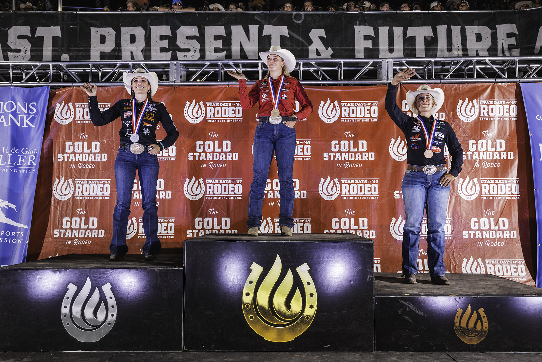 Left to right, Shelby Meged, Beau Peterson and Maddy Jacobs on the podium for the Days of 47 Rodeo in Salt Lake City.