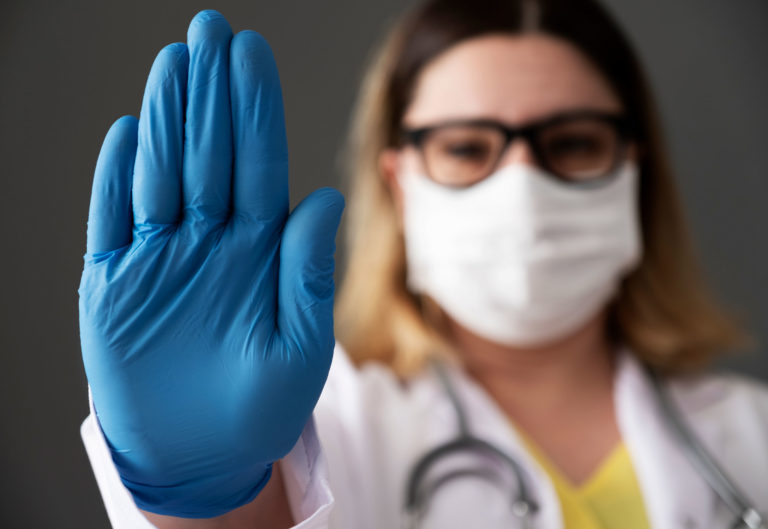 vet woman mask glove hand up stop