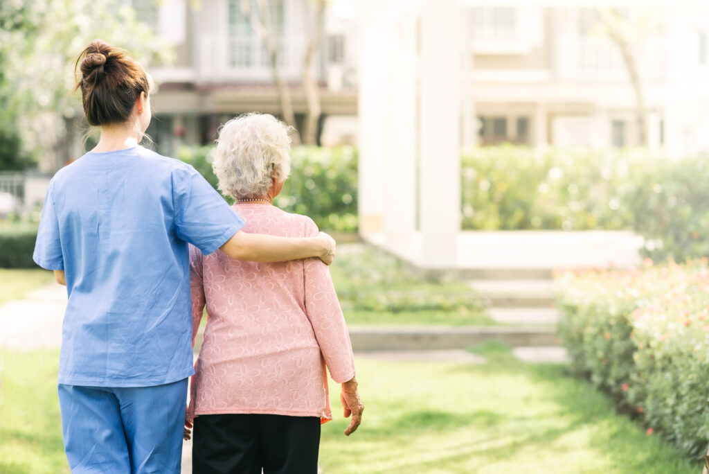 Caregiver and patient, caregiving for elderly woman.