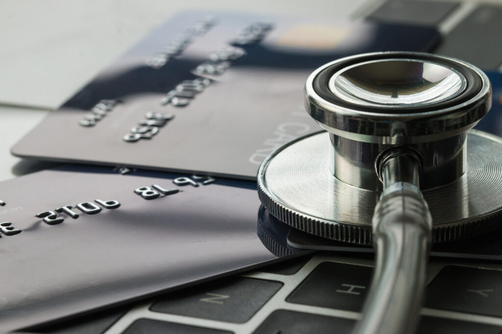 Credit card and stethoscope, illustrating payment at time of service (PATOS) in equine practice.