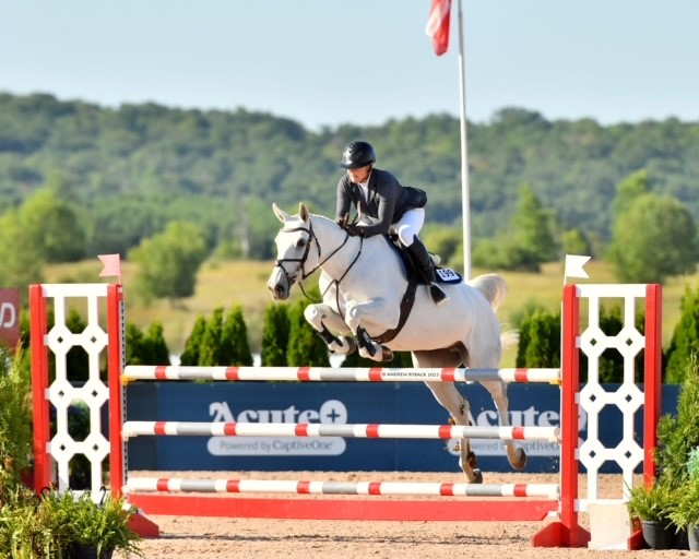 Dr. Lori Bidwell competing in showjumping. 