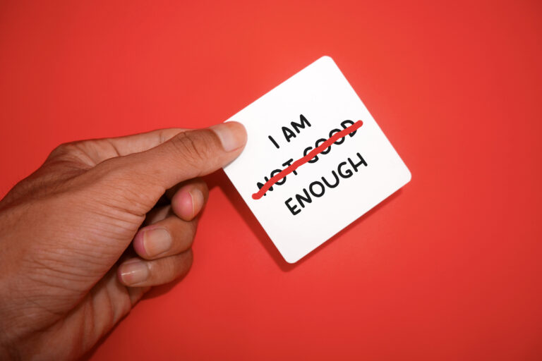 text I AM NOT GOOD ENOUGH with a red strikethrough on NOT GOOD, mental health concept, self-confidence and change negative inner
