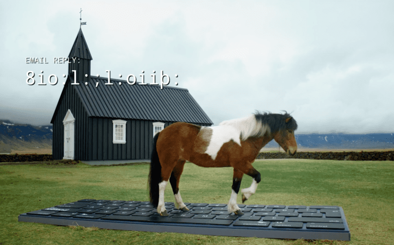 An Icelandic horse standing on a giant keyboard with a church in the background