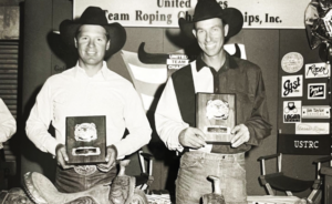 Jake Barnes and Clay O'Brien Cooper pose with their buckles.