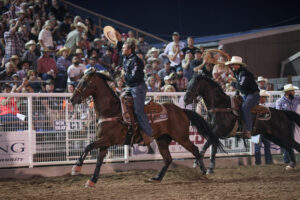 Tyler Wade and Wesley Thorp taking a victory lap in Caldwell, Idaho, at the 2023 Caldwell Night Rodeo.