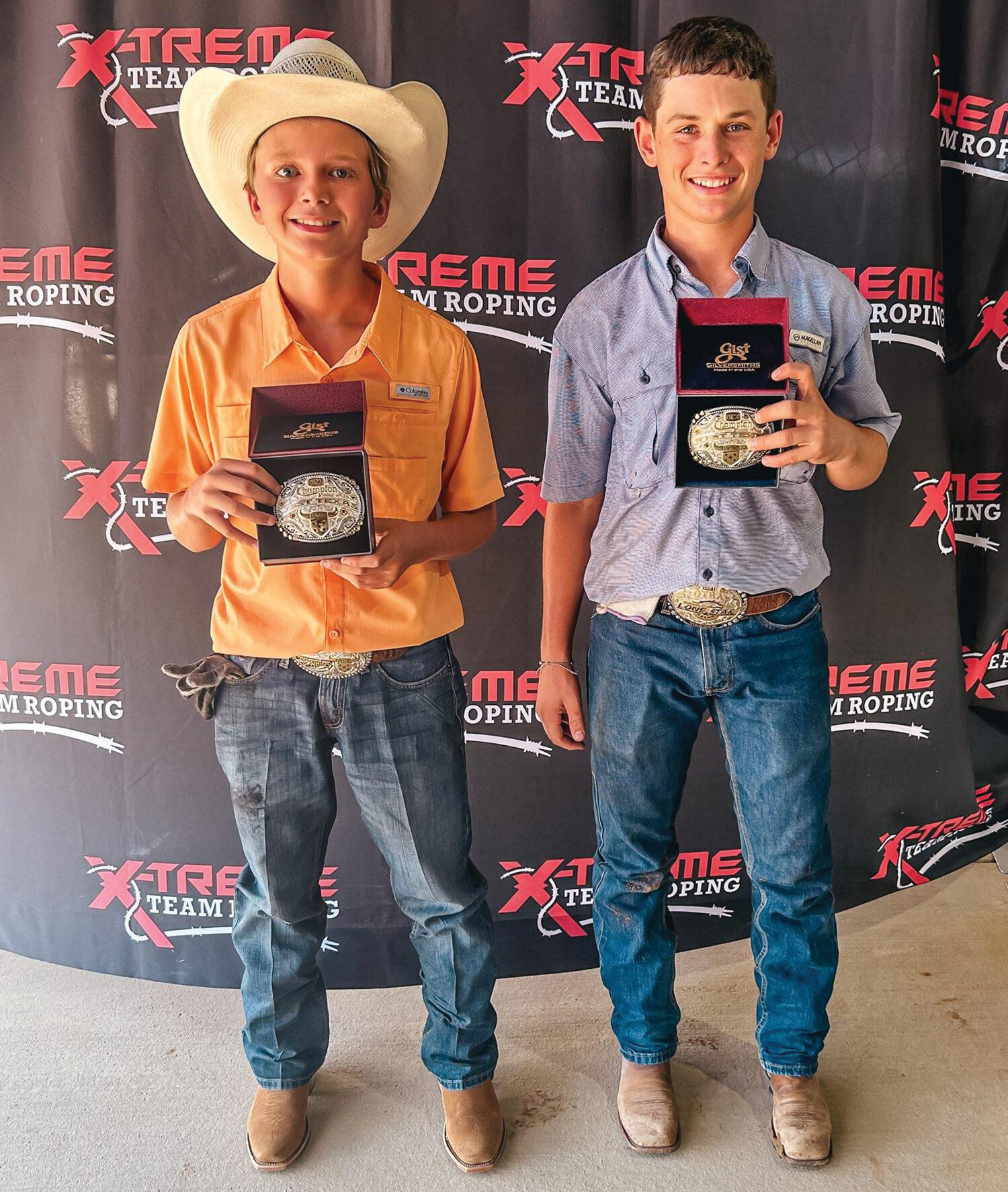 Colt Hilley and Hagen Wright posing with trophy buckles.